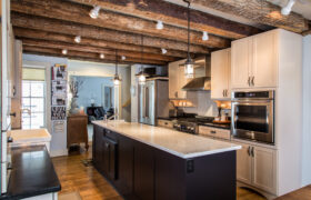 Custom home remodeling milwaukee: The Farmhouse Kitchen with wood ceiling beams and kitchen island