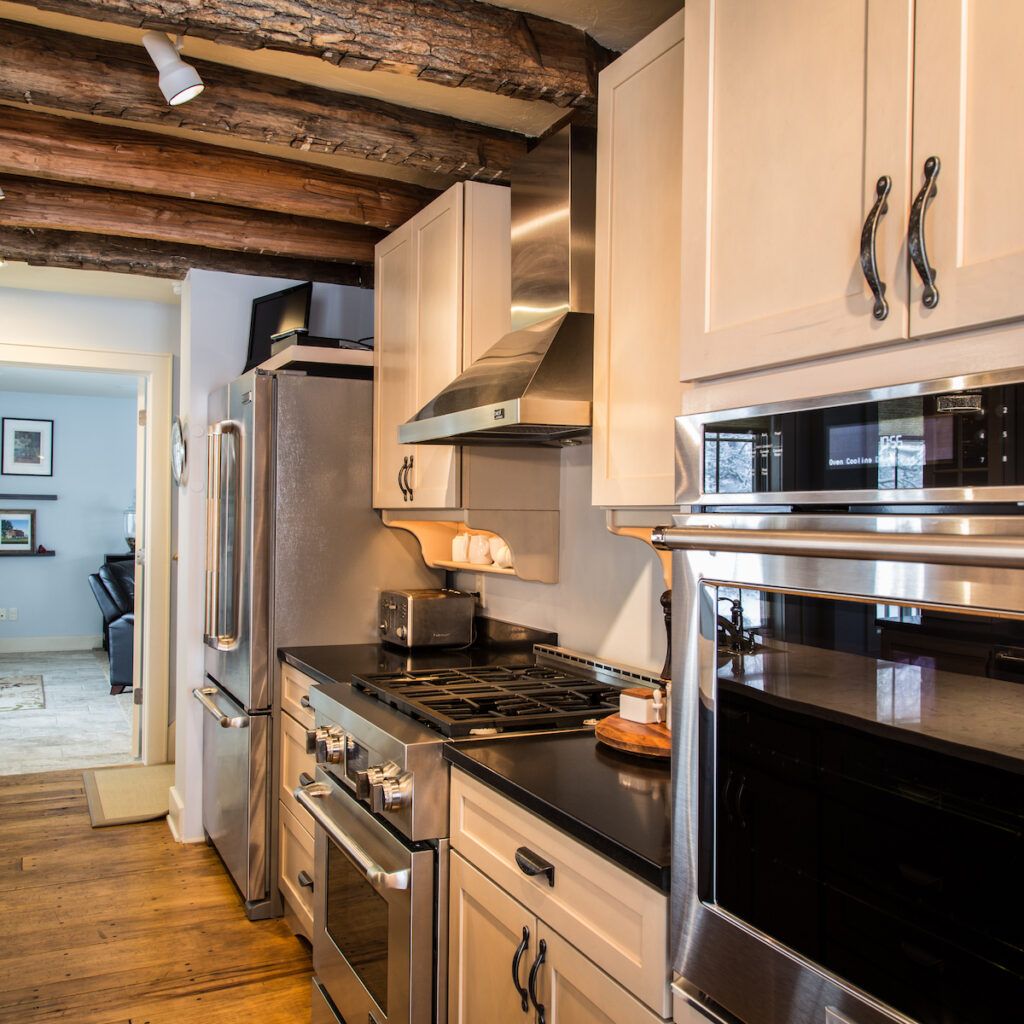 Wall oven with white cabinets and nickel plated hardware.