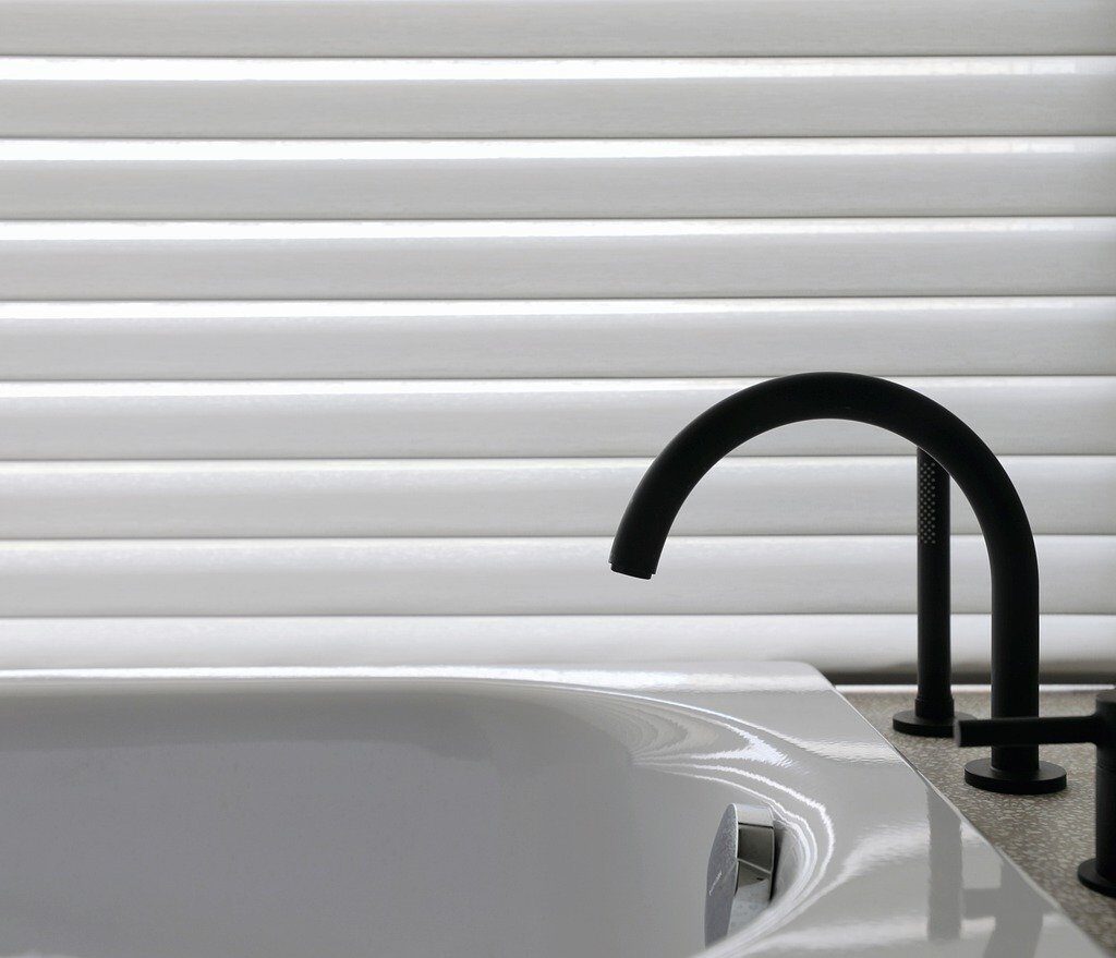 Soaking tub with sleek black faucet