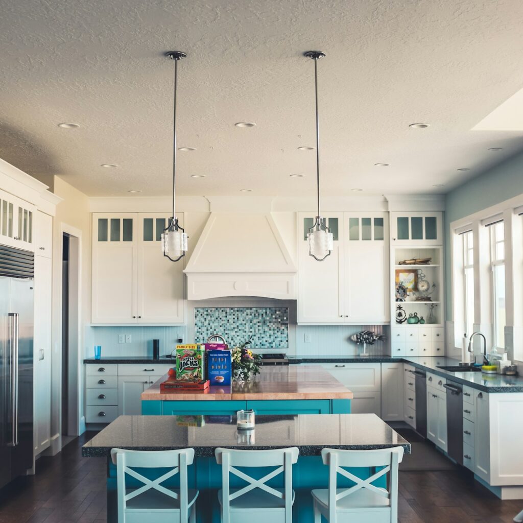 Bright, luxury kitchen with a teal kitchen island